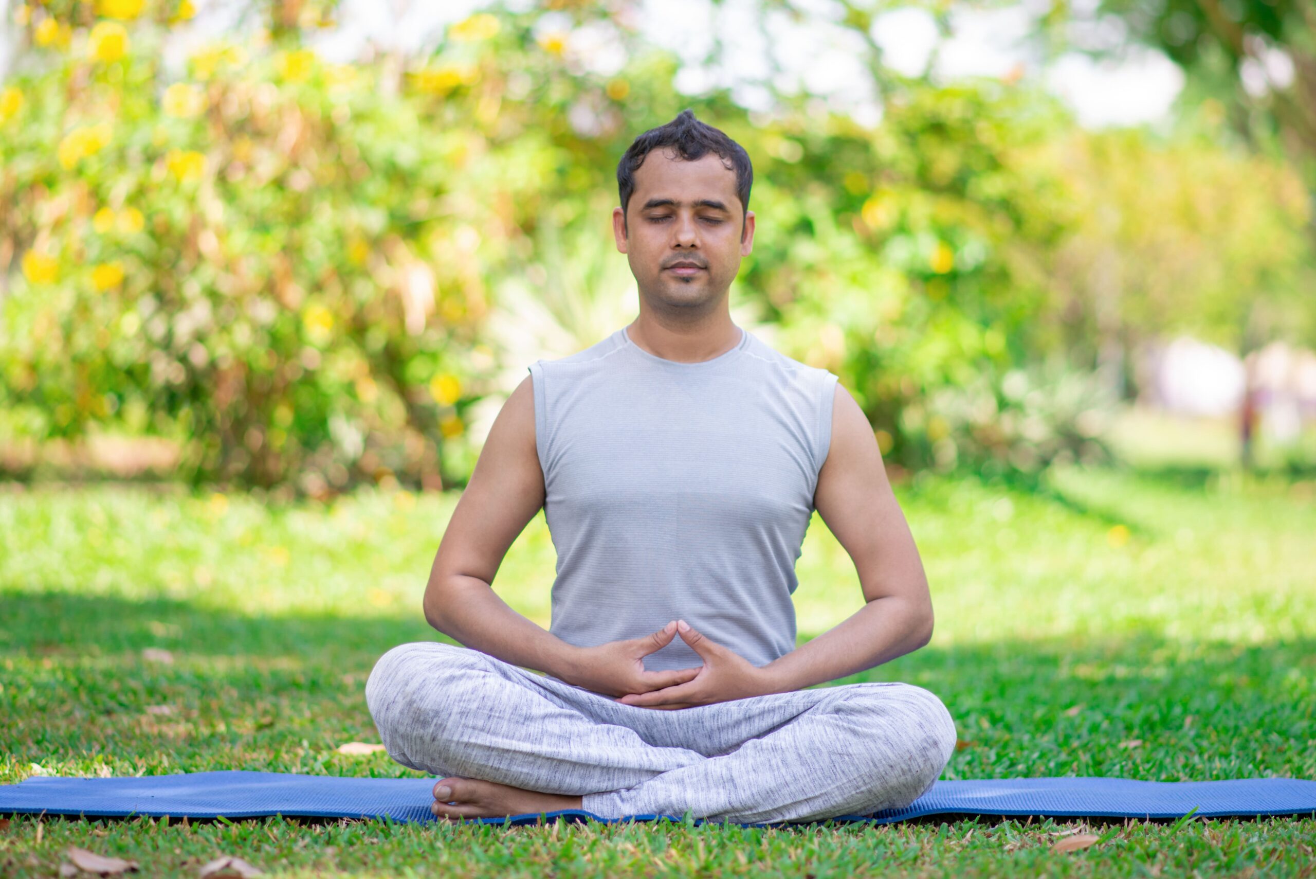 focused young indian man meditating lotus pose (1)